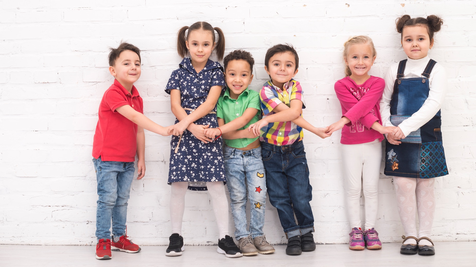 children holding hands office building for consulting services